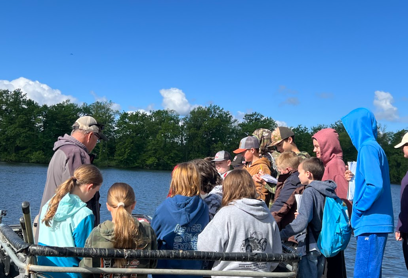 Kids watching Mr.Brecka shocking fish. 