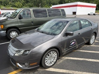 2011 Ford Fusion Hybrid car doesn't run light gray color, and a 2005 Ford Van (10 passenger) green in color runs