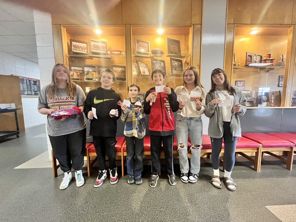 Six students pose for a picture, all holding a prize.