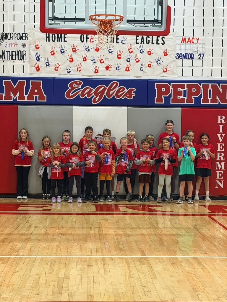 Kindergarten through first grade holding up their ribbons.