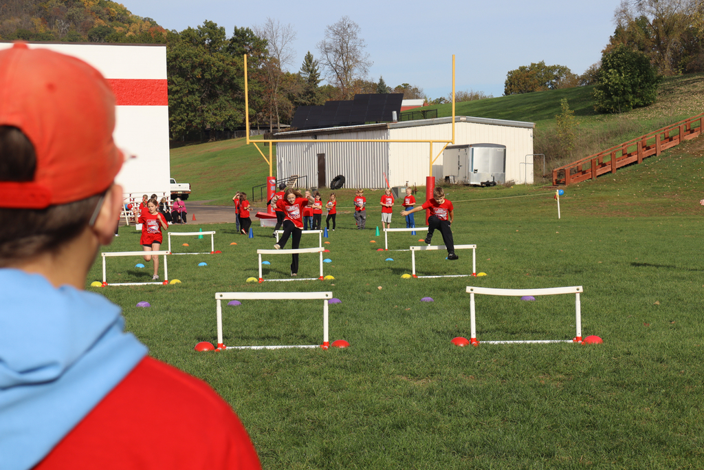 Students jumping hurdles.