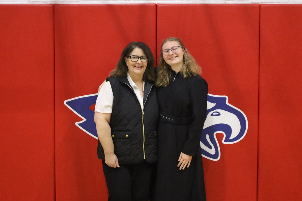Lorna Lisowski and Joan Draxler Ruff posing in front of the Eagle logo.