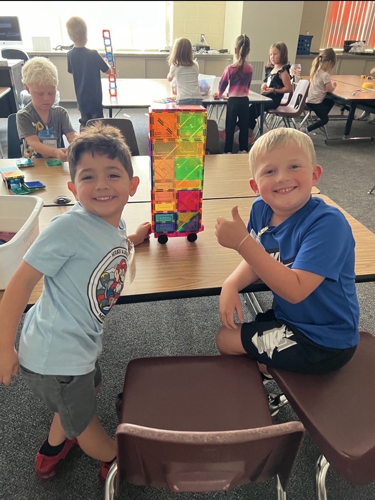 Students work together to build a structure with colorful panels.