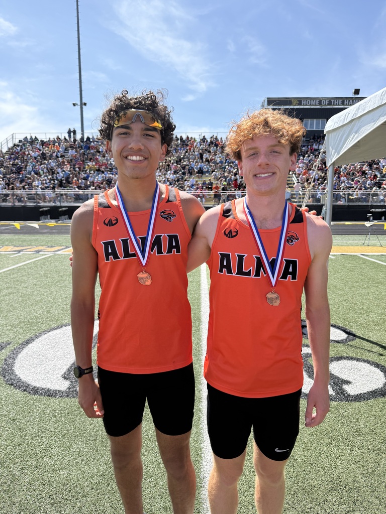 Two AHS All-State Athletes pose together in uniforms with medals