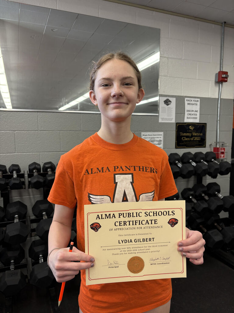 Student poses with attendance certificate