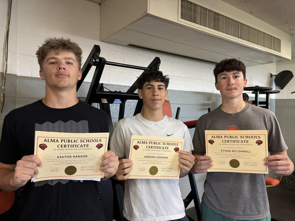 Three students pose with attendance certificates