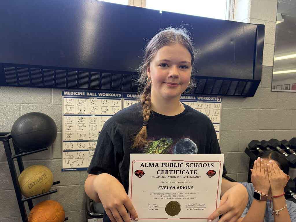 Student poses with attendance certificate