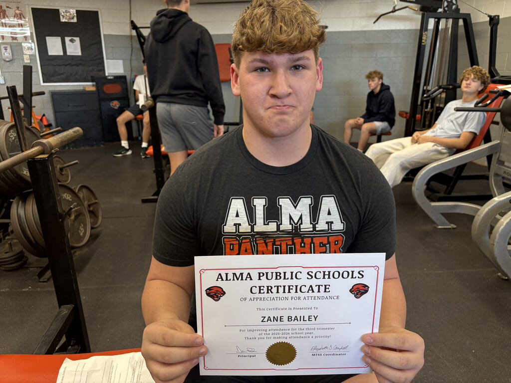 Student poses with attendance certificate