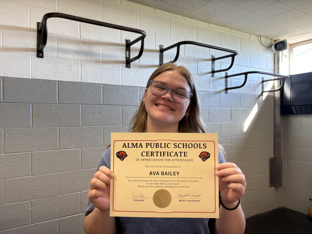 Student poses with attendance certificate