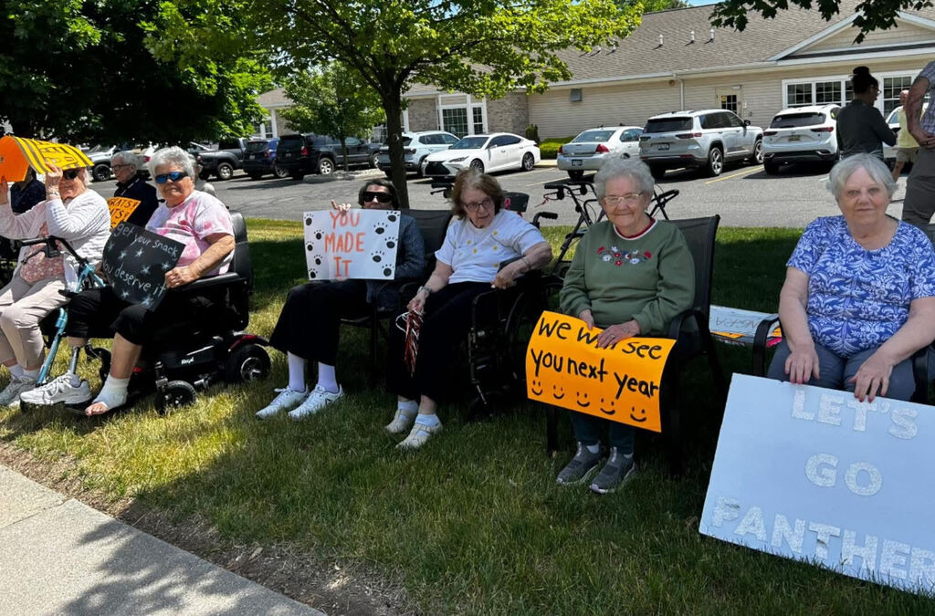 Arbor Grove residents with encouraging signs for students