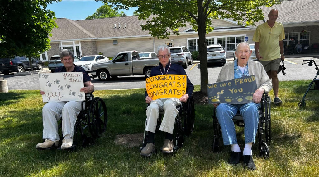 Arbor Grove residents with encouraging signs for students
