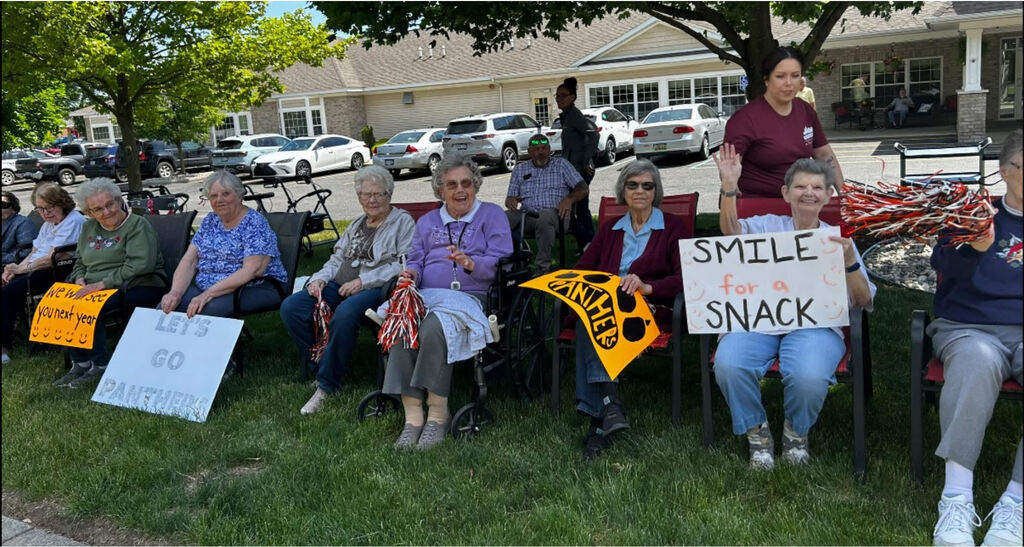 Arbor Grove residents with encouraging signs for students
