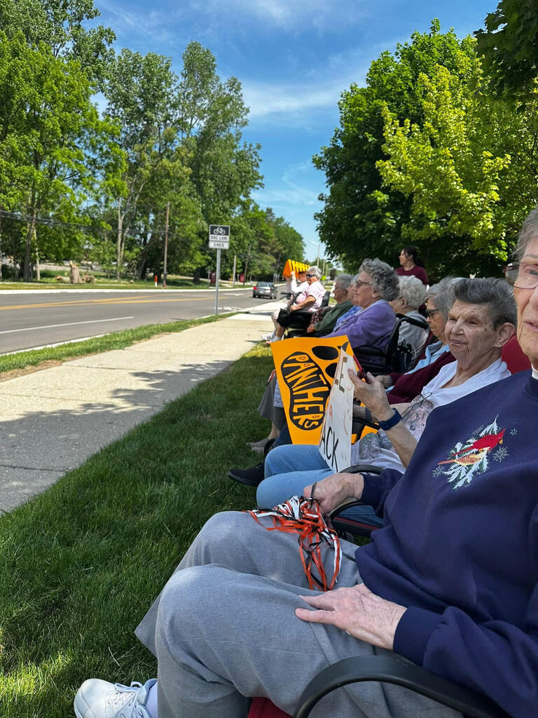 Arbor Grove residents with encouraging signs for students
