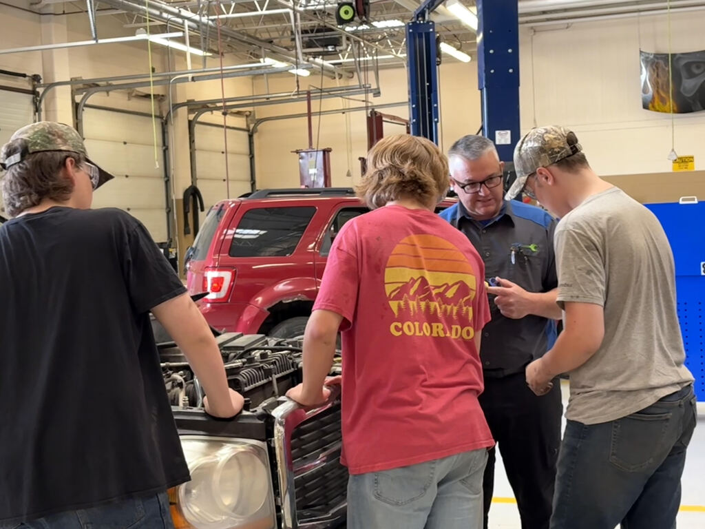 CTE summer camp students with automotive instructor