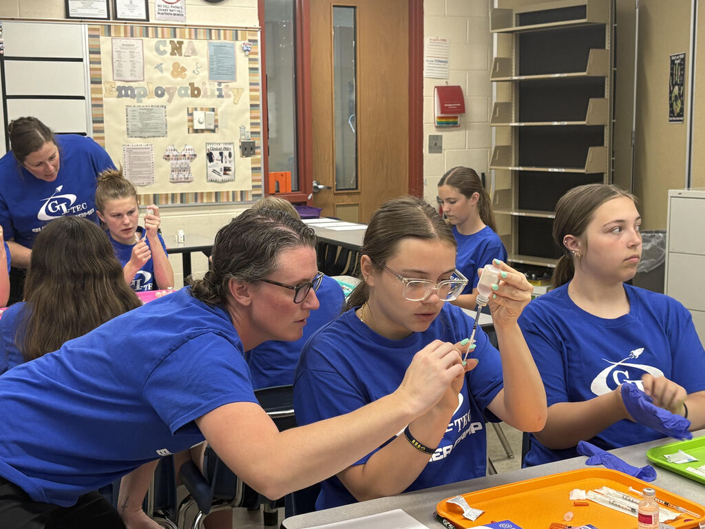 CTE summer camp students practicing injections