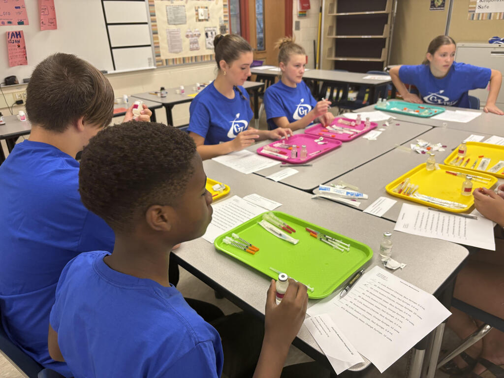 CTE summer camp students practicing injections