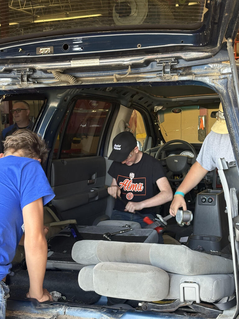 Automotive students working on car