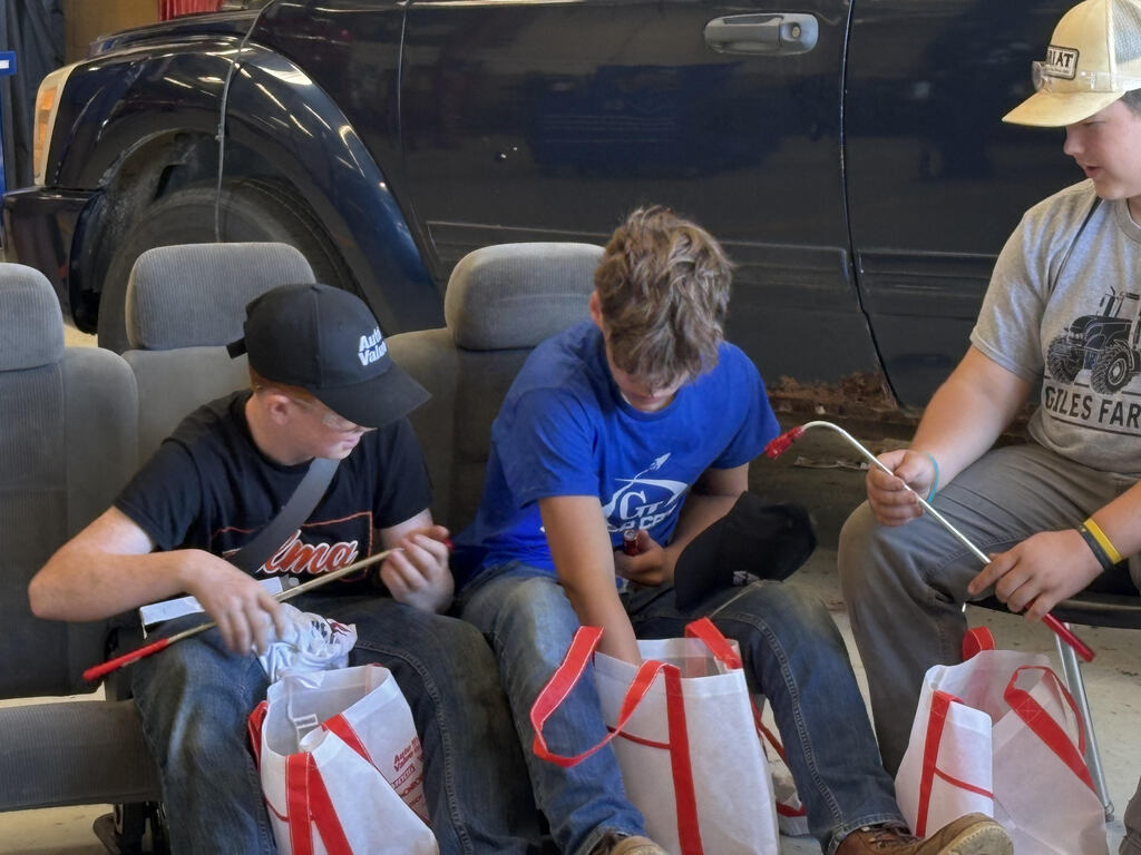 Automotive students looking at gift bag content