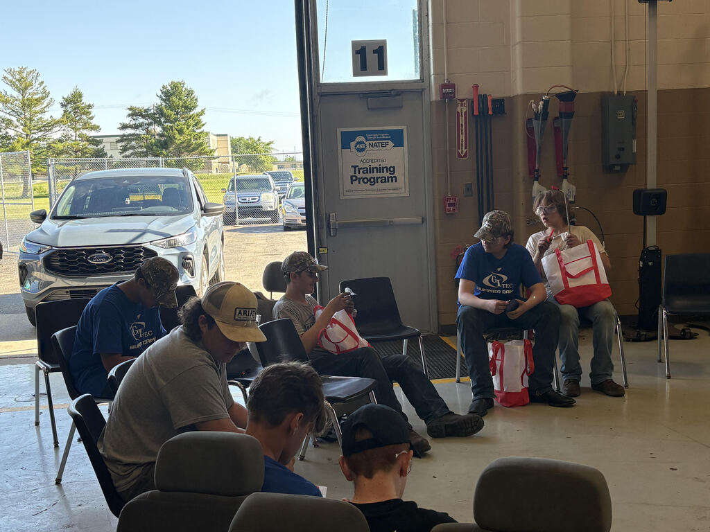 Automotive students looking at gift bag content