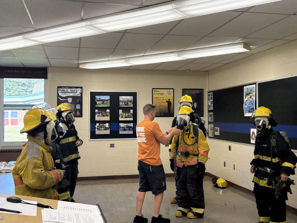 Firefighting students taking off gear