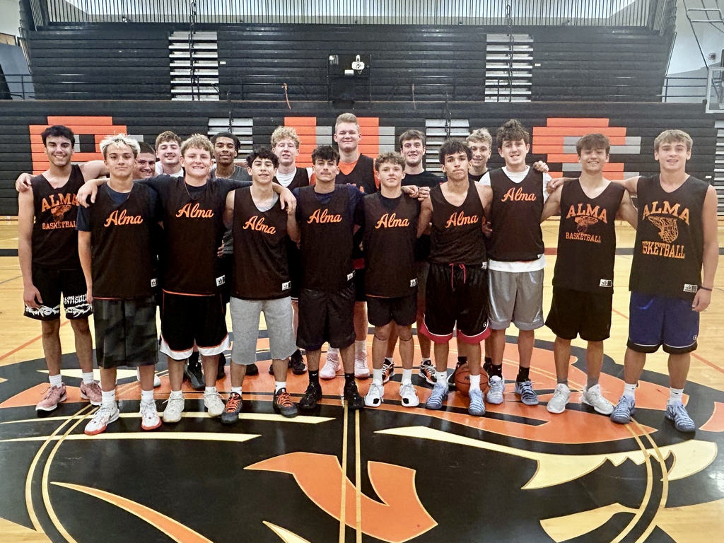 17 AHS Panther basketball players pose for a group photo in the gym