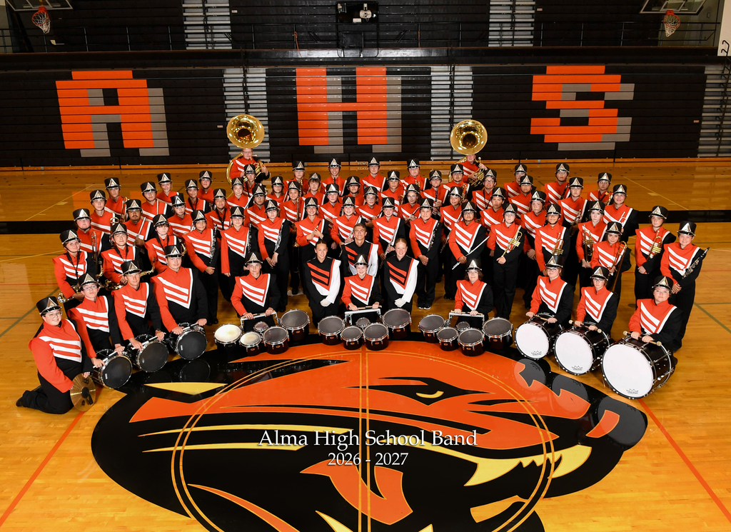 Group photo of AHS band (2026-27) in gym, surrounding Panther head image on floor