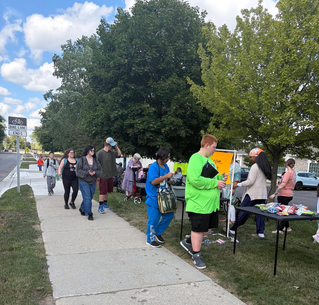 Arbor Grove residents and staff pass out snacks to APS students