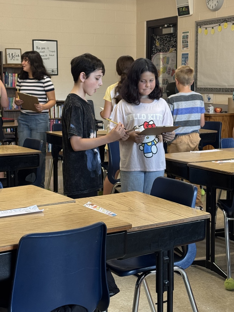 Two 5th graders working hard at math in the classroom