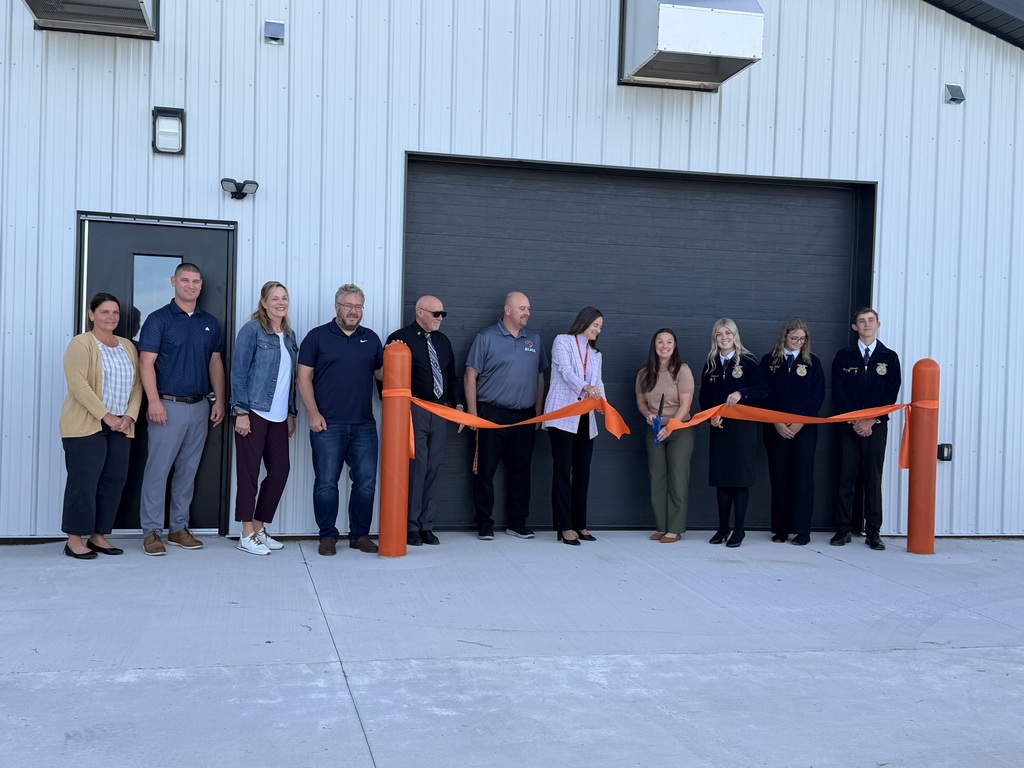 Ag teacher cutting the ribbon with Superintendent and Board of Education members.