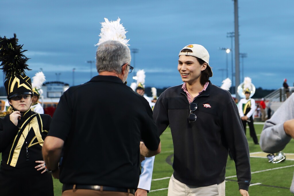 Current and former Alma High School Band directors presented championship rings to the students who made the achievement possible, including members who have since graduated.
