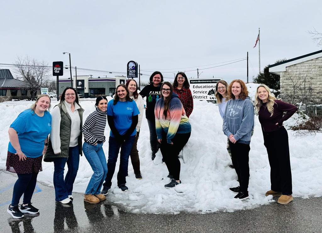 Training participants standing in snow bank.