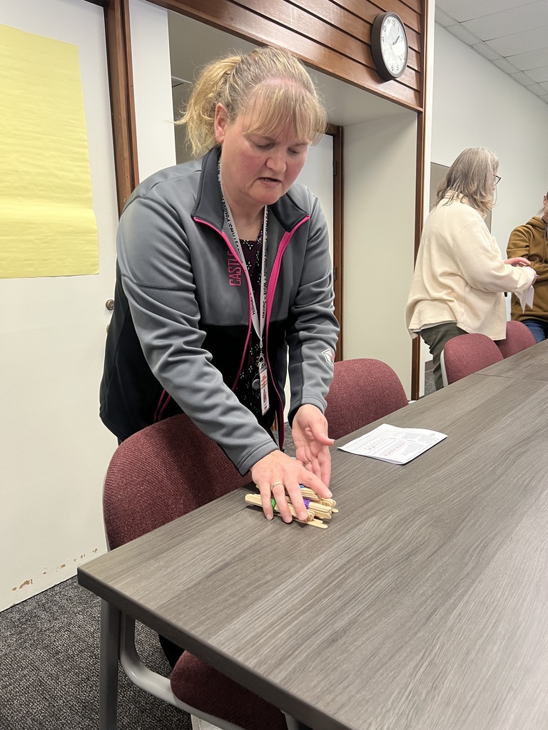 A teacher practices the place value assessment using bundles of popsicle sticks