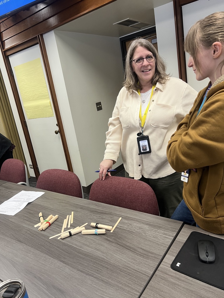 Teachers practice a place value activity with bundles of popsicle sticks