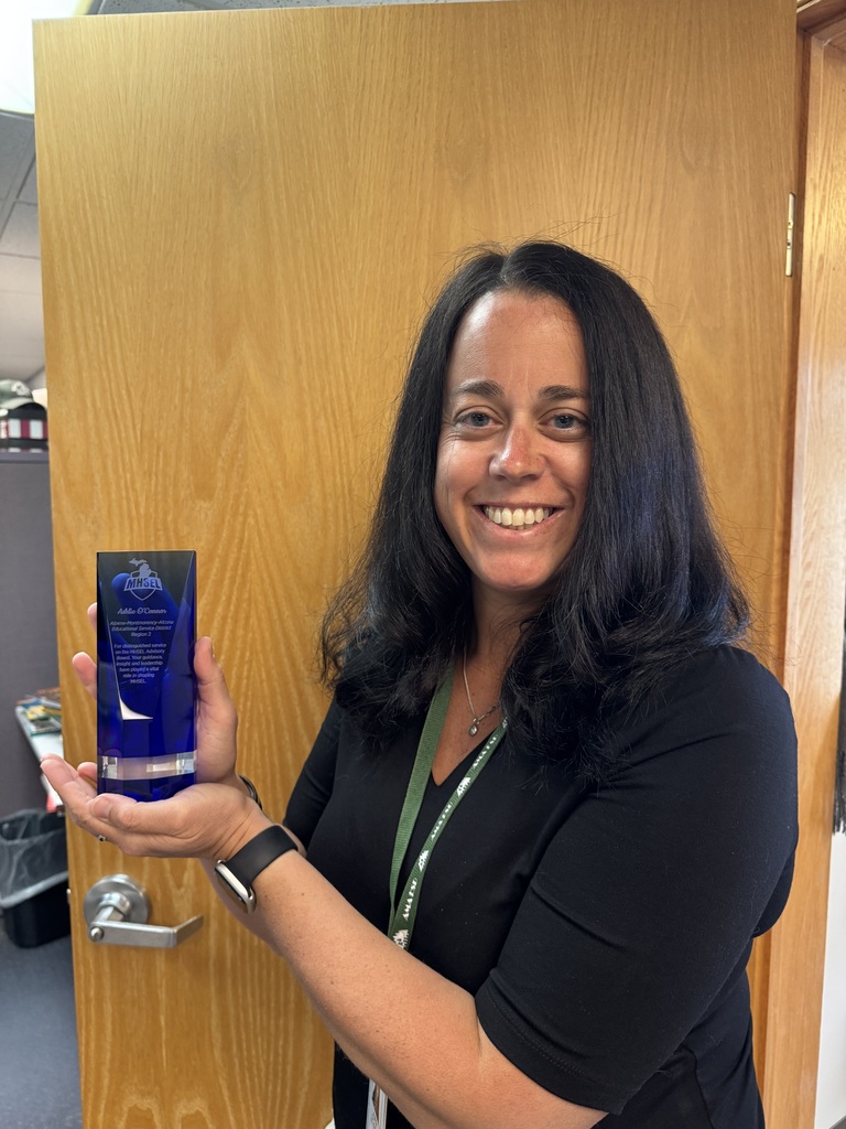 Ashlie O'Connor holding recognition award