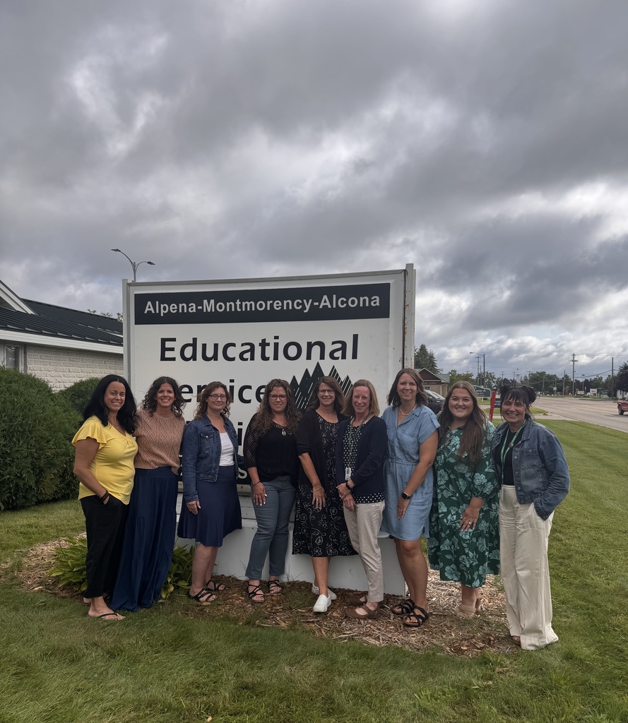 Instructional Services Team standing by AMA sign