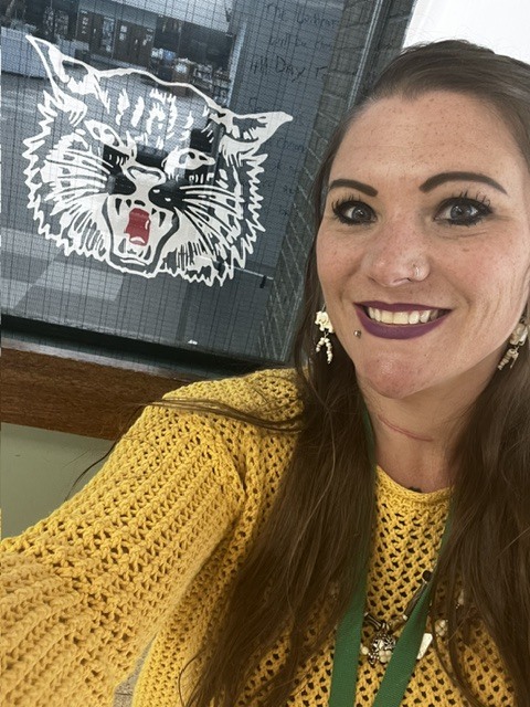 Kass Showalter - School Social Worker standing in front of the AHS Wildcat Logo.