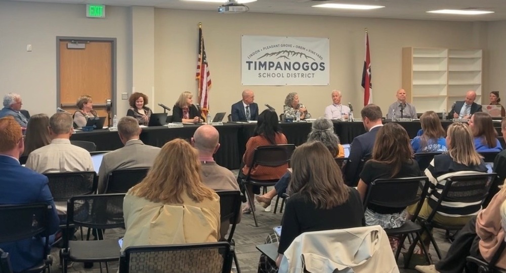 Timpanogos School Board members meeting in front of a large group.