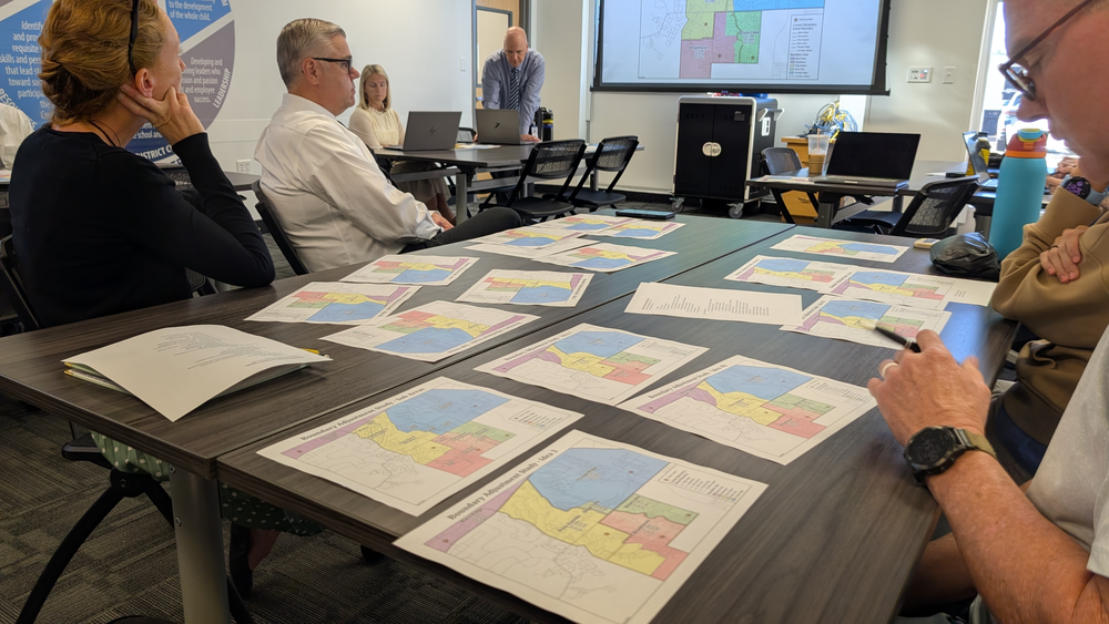 a boundary committee meeting with maps on tables