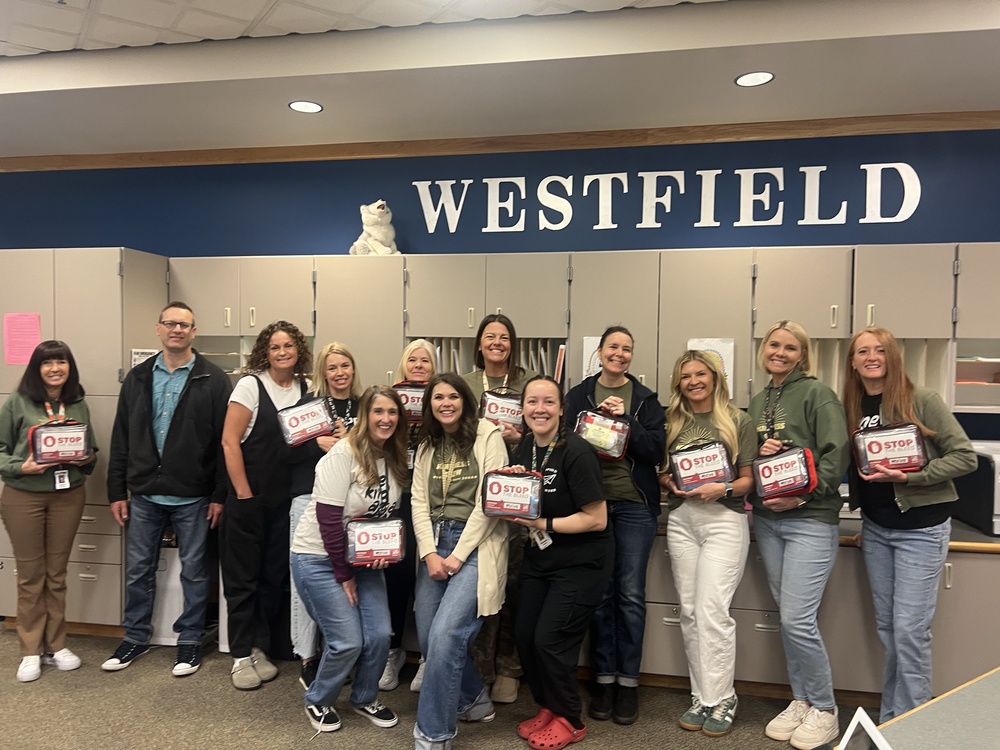 Teachers holding our new "Stop the Bleed" kits