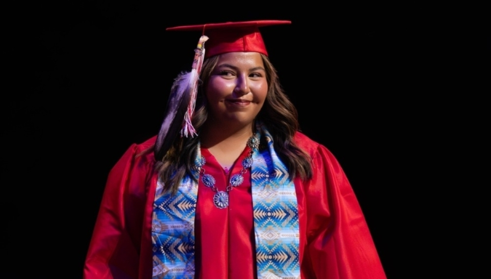 graduate with ceremonial feather