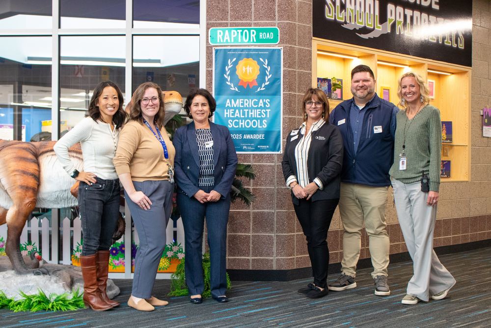 Group of people standing in front of banner saying "America's Healthiest Schols"