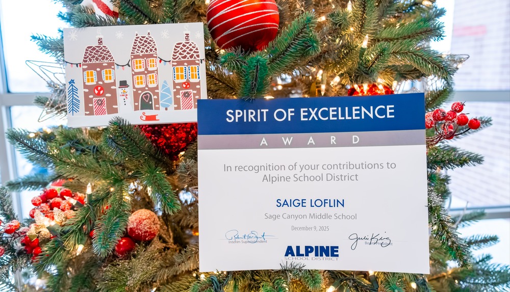 Image depicting a holiday card with an award certificate next to a christmas tree.