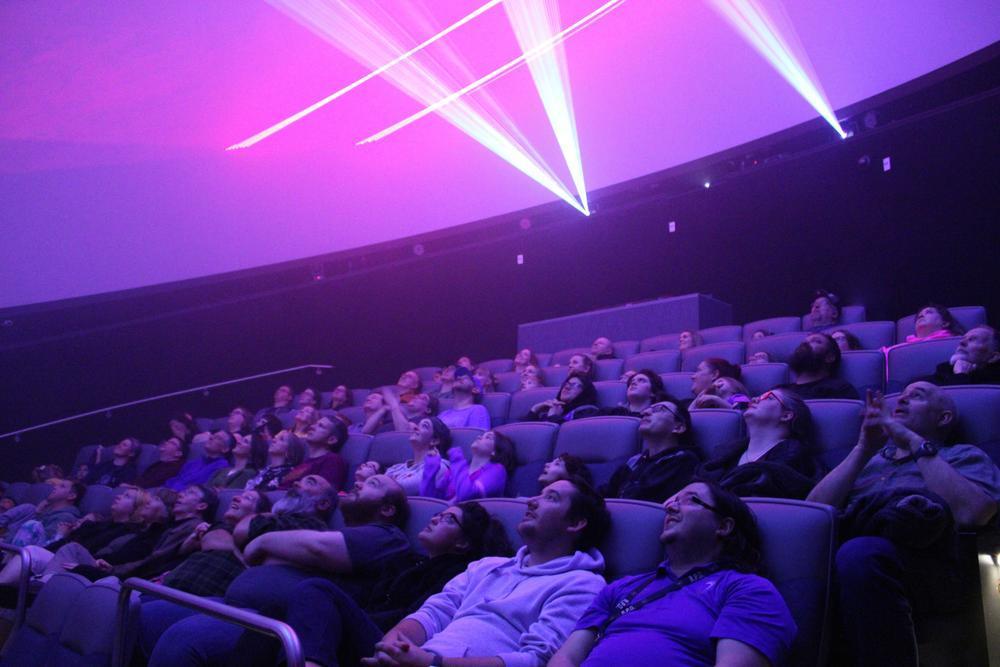 audience watches a laser show