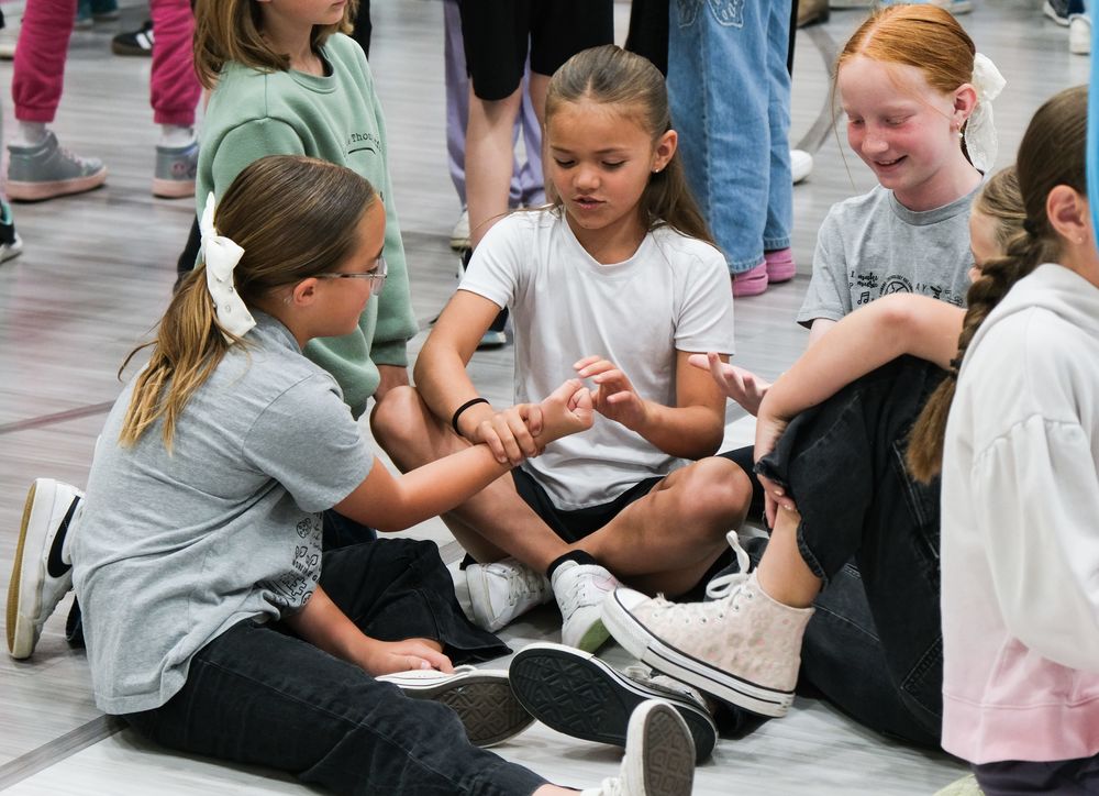 young students play in a school gym