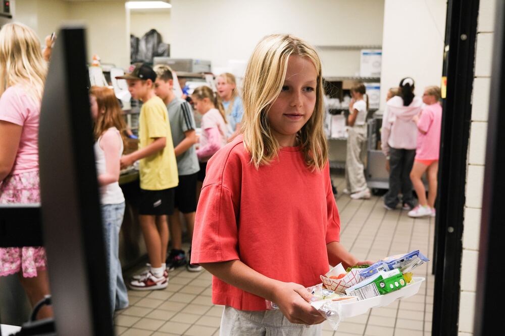 a student gets lunch at an elementary school