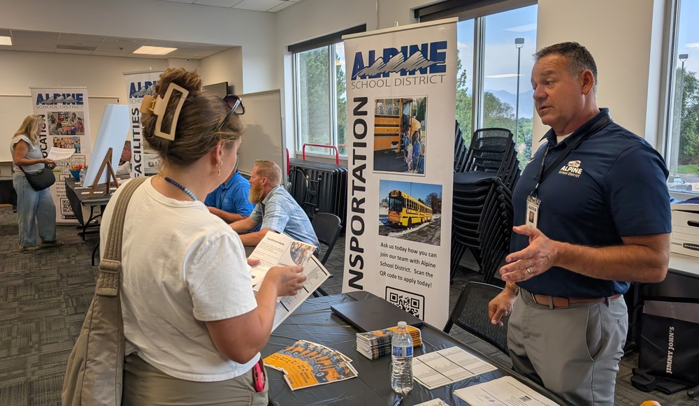 a man explains a job to a fair attendee