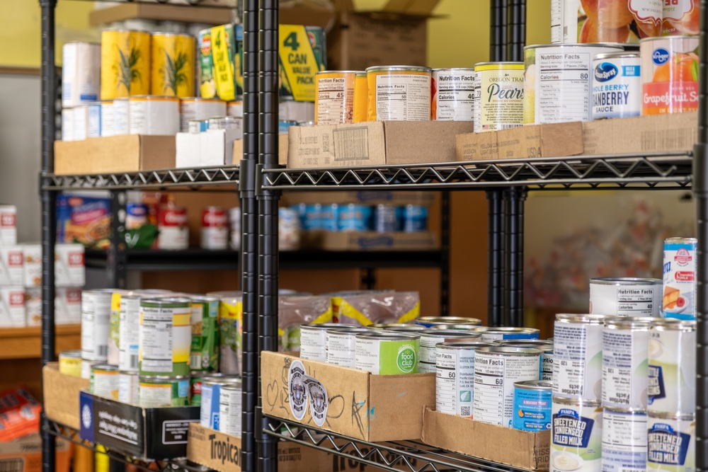 Canned food lining a storage shelf