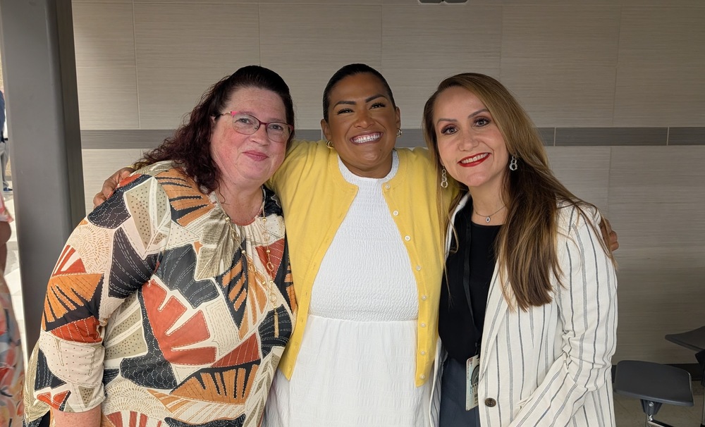 three administrators smiling for the camera