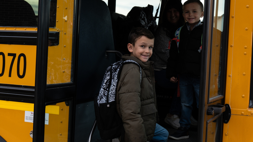 a student boards a school bus