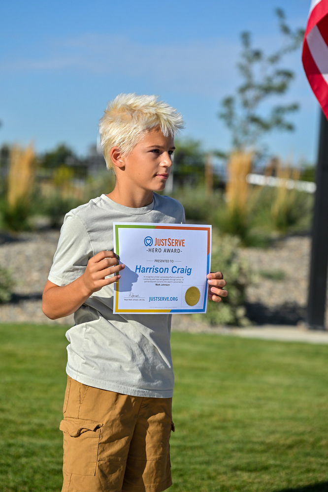 Harrison Craig Holding his Just Serve Award certificate
